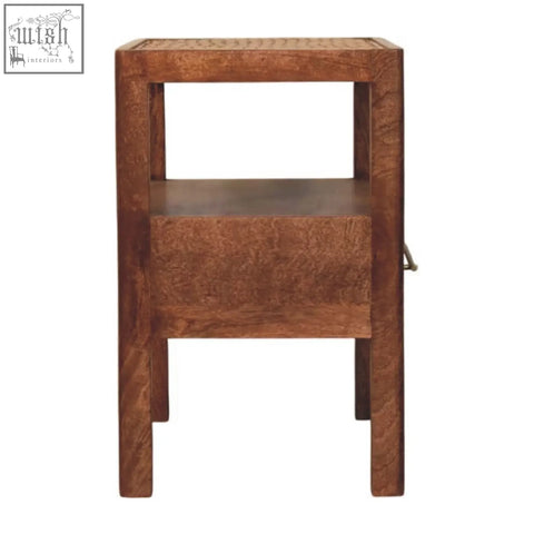 A honey caramel caldera bedside stand with woven cane top, open shelf, and a brass handle drawer