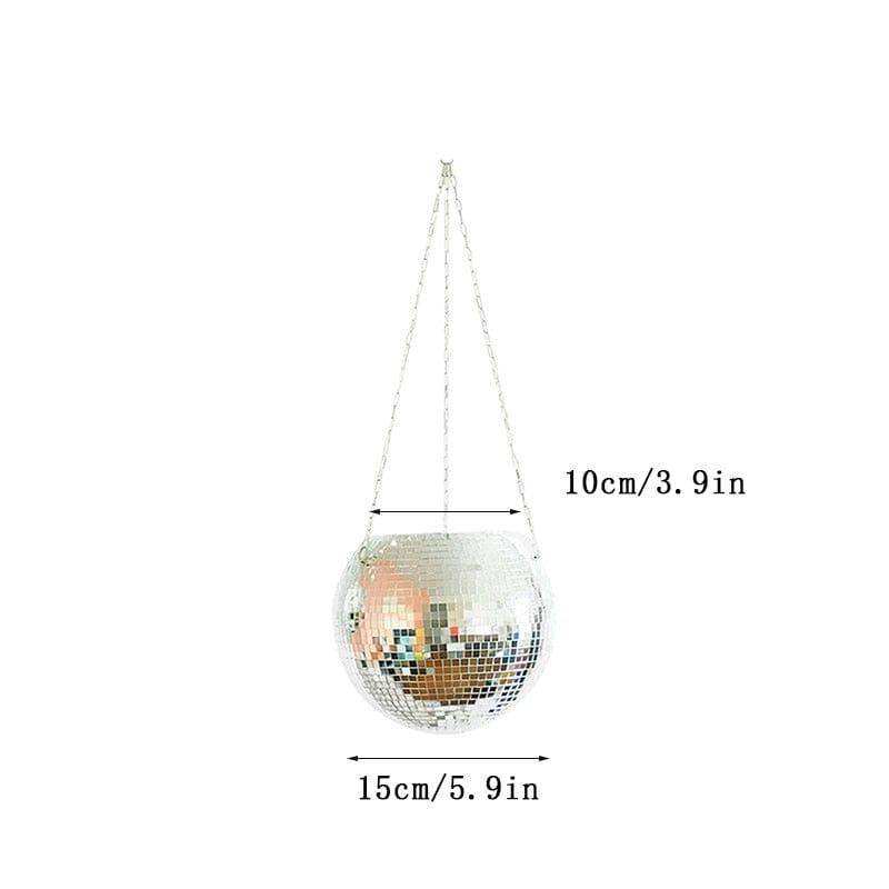 A disco ball planter with a mirrored silver and iridescent surface made of small tiles hanging by three thin chains