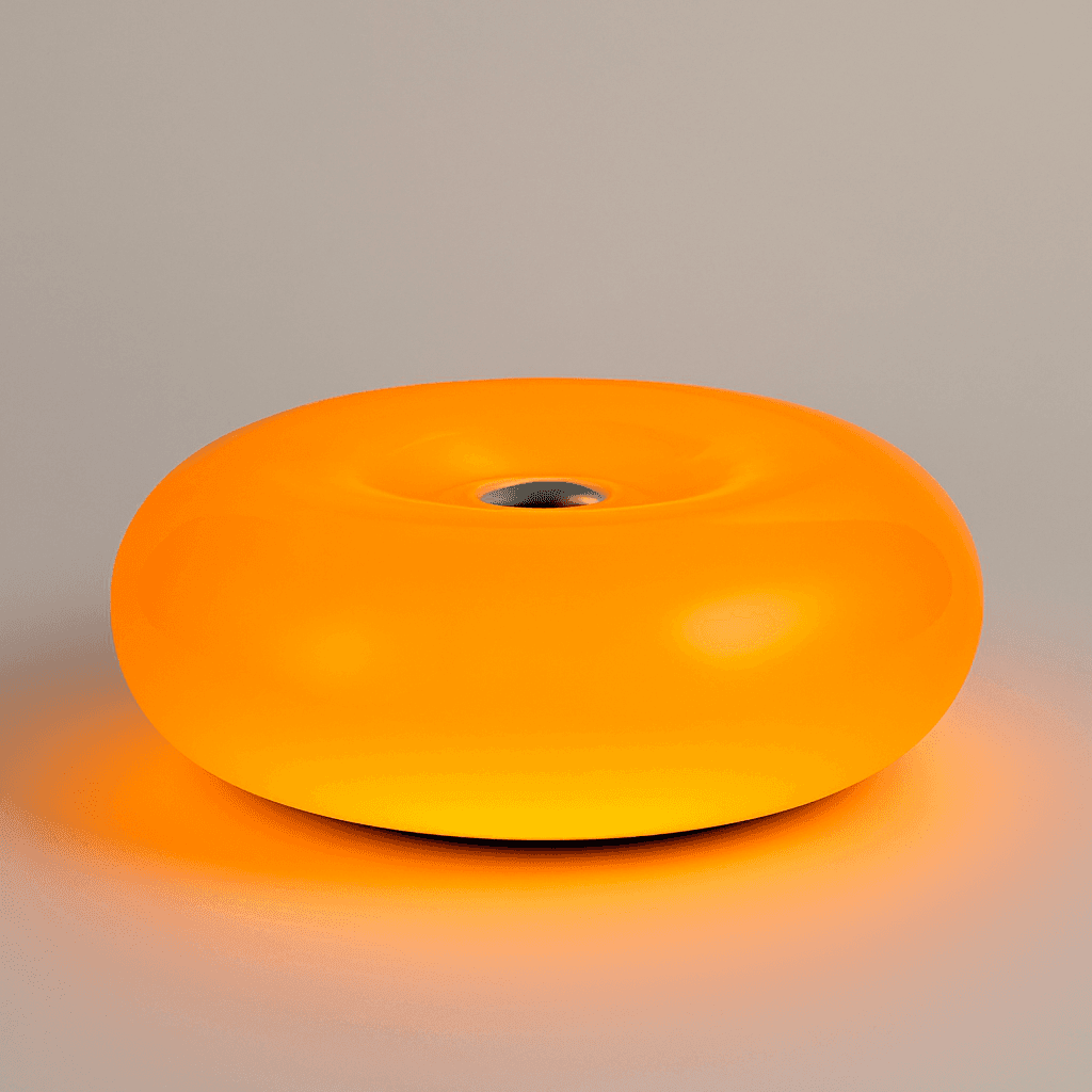 The donut lamp is a glowing orange ambient orange lamp with a smooth translucent plastic body and a metal center hole