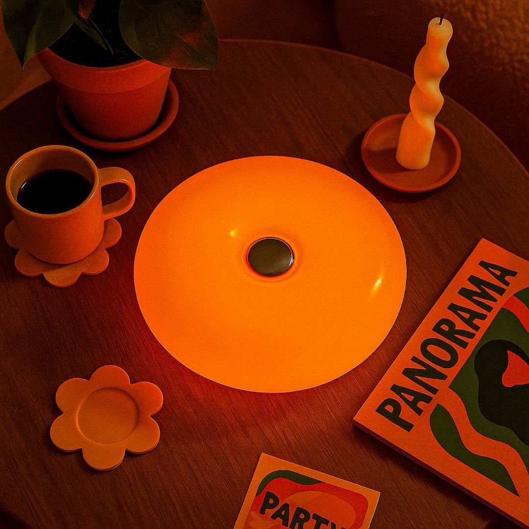 Vibrant orange donut lamp with smooth glossy finish and central dark button perfect as ambient orange lamp