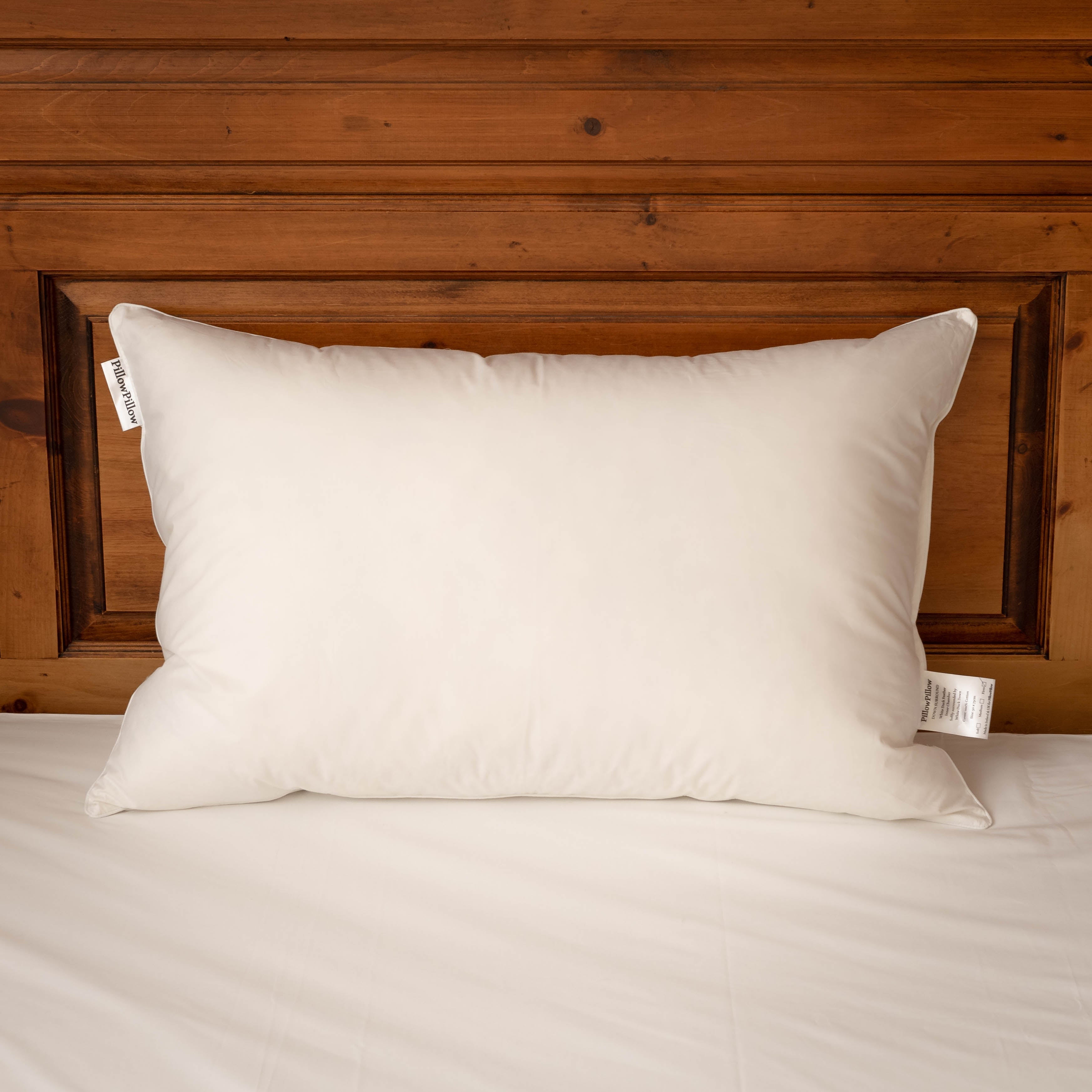 White rectangular surround pillow with smooth fabric cover and central chamber filled with white duck down and feathers