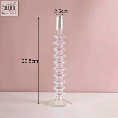 Clear glass candle holder with a spiraled textured body and flared base perfect for holding glass candles