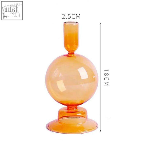 A translucent amber glass candle holder with a spherical body narrow neck and flared base perfect for glass candles