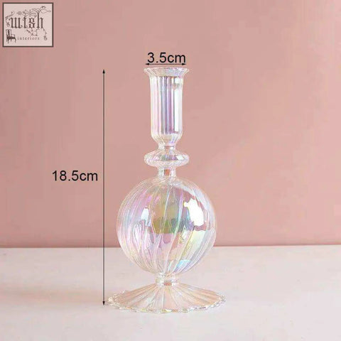 The glass candle holder features an iridescent fluted spherical body with a slender stem for elegant decor