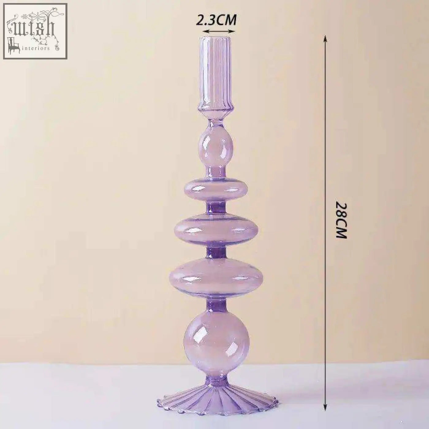 A tall translucent lavender glass candle holder with a fluted base and stacked spherical segments perfect for candles