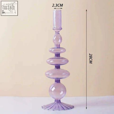 A tall translucent lavender glass candle holder with a fluted base and stacked spherical segments perfect for candles