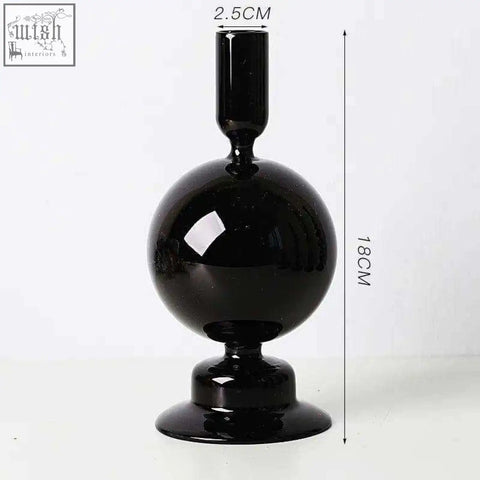 A sleek black glass candle holder with a glossy spherical body and slender neck perfect for glass candles