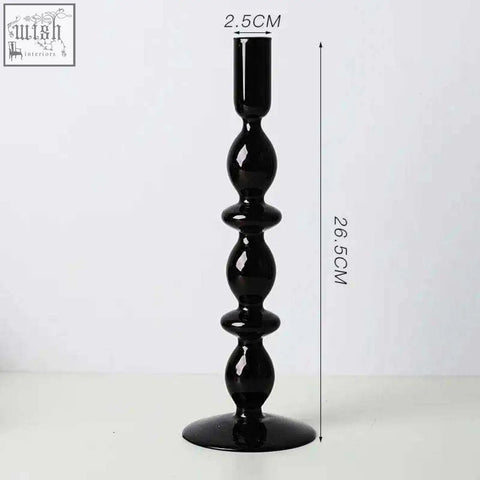 Black glass candle holder with glossy finish and segmented bulbous design perfect as a stylish glass candle holder