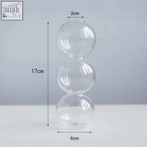 Clear glass candle holder with three stacked spherical sections perfect for holding glass candles or tealights