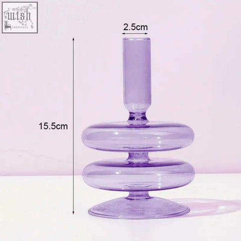 The glass candle holder is a translucent lavender glass candle holder with a tiered ring base and slender top