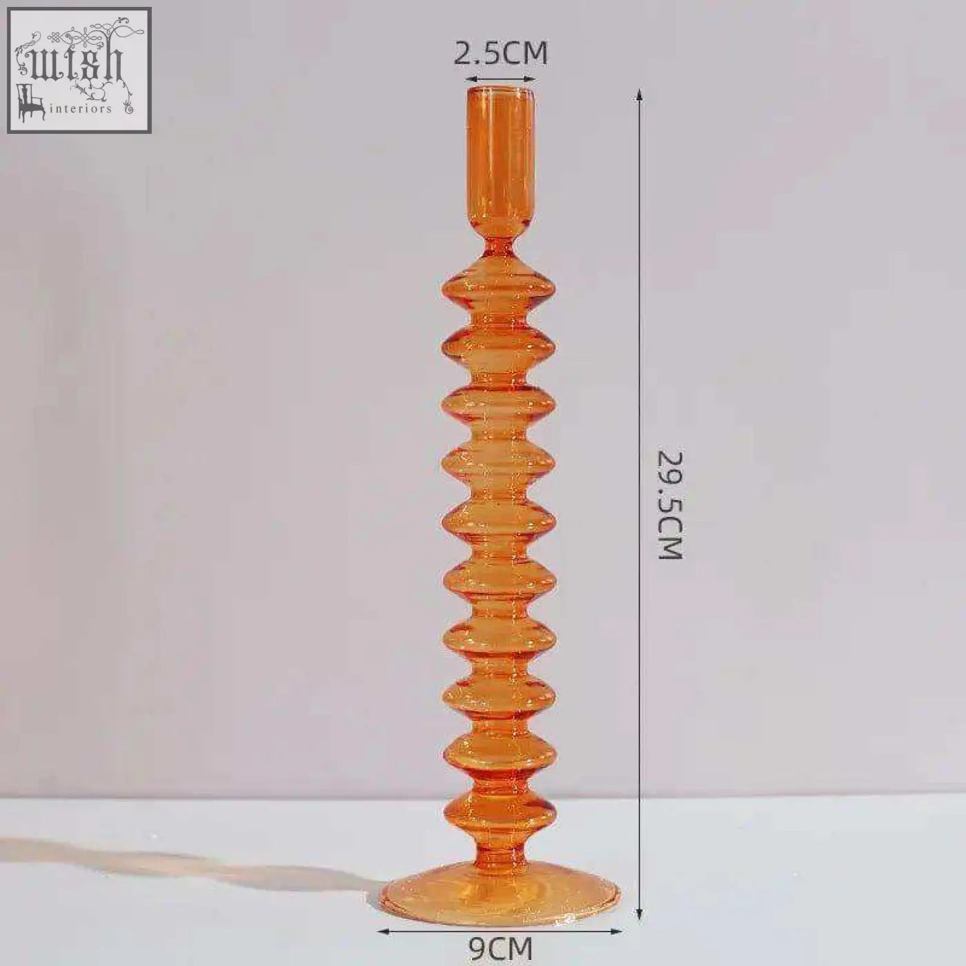 Tall amber glass candle holder with textured segmented design and flared base perfect for glass candles
