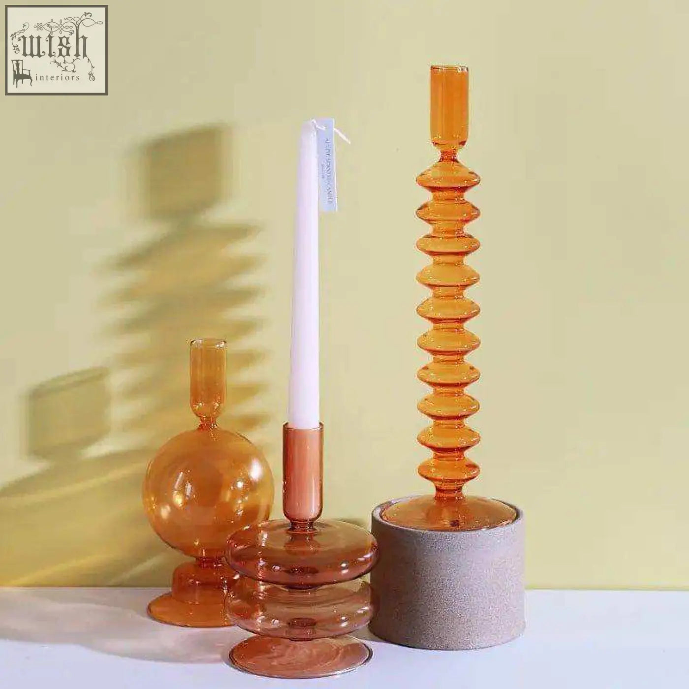 Tall amber glass candle holder with spiral segmented design and copper-toned base perfect for any glass candle setup