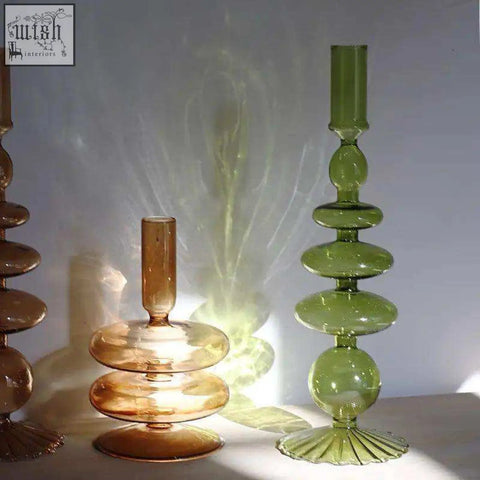 Tall tiered glass candle holder in amber and green hues with a modern sculptural design for stylish decor
