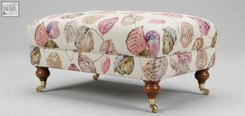 The Highland Foot Stool cream ottoman with watercolor leaf pattern features a solid wood frame leg option and high density foam