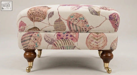 The highland foot stool cushioned ottoman with cream fabric, intricate leaf shell pattern, solid wood frame, and high density foam