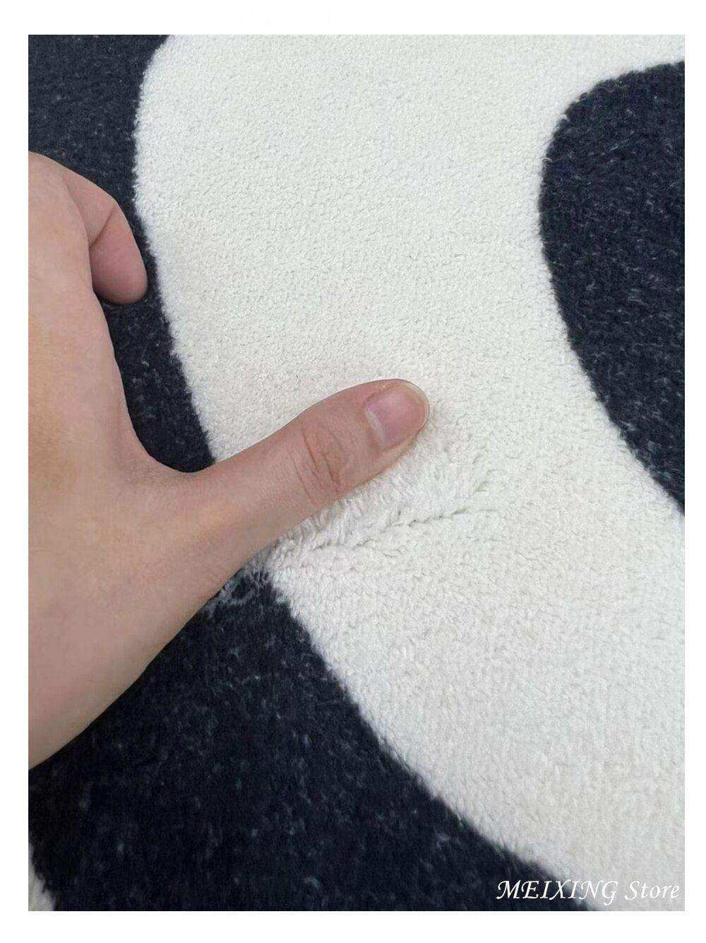 Plush black and white panda-themed illusion rug with a soft textured surface perfect for cozy floors