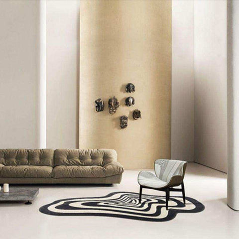 A sleek armchair with white and gray striped fabric and dark wood legs placed on the illusion rug