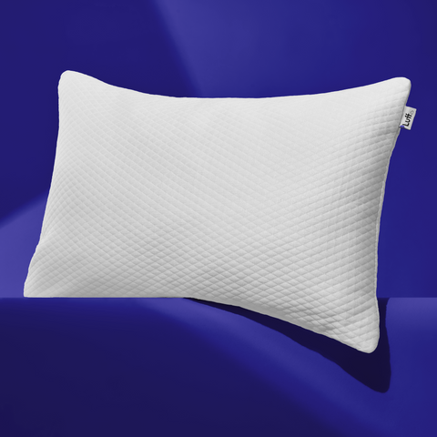 White quilted luxury bamboo pillow with subtle diamond pattern and small brand tag on corner for comfortable sleep