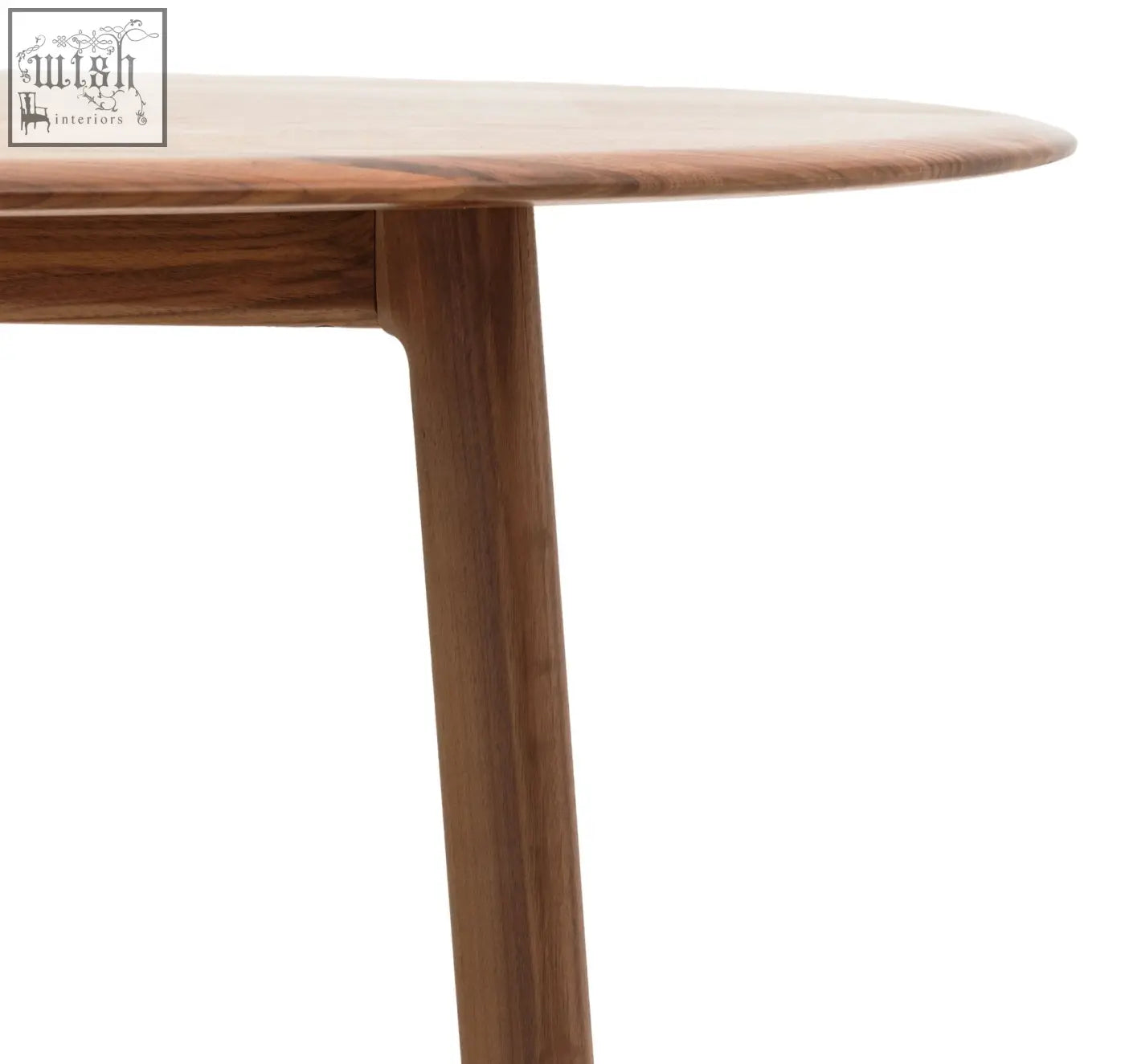 A sleek med dining table made of solid walnut with soft edges and a smooth medium brown finish
