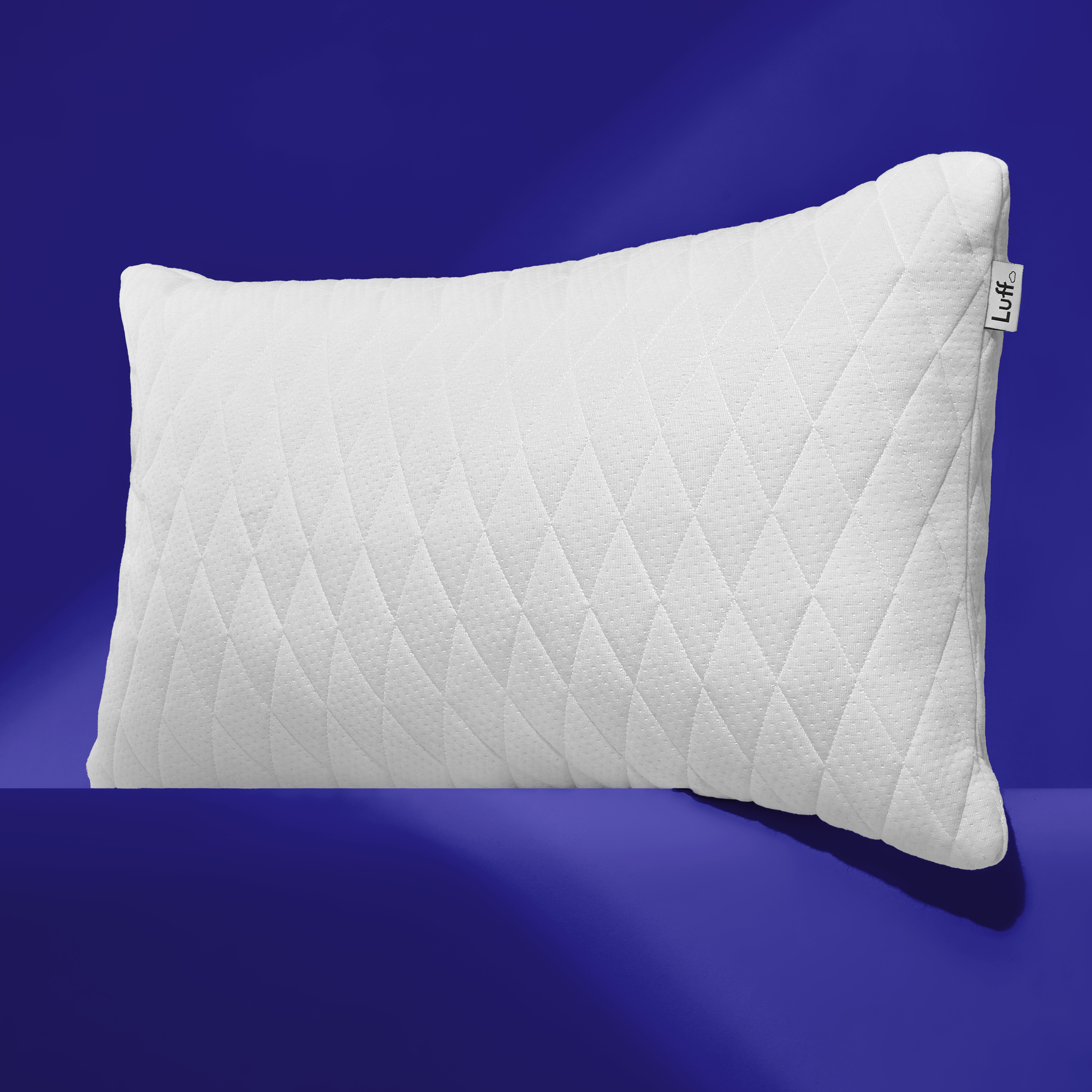 White quilted adjustable bamboo pillow with diamond stitching and luff brand tag on the corner
