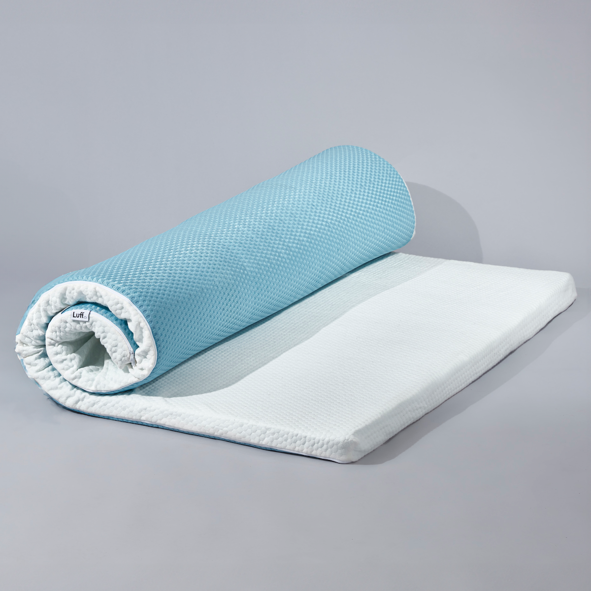 Light blue and white rolled memory foam mattress topper with textured surface for The Prestige Bamboo Mattress Topper