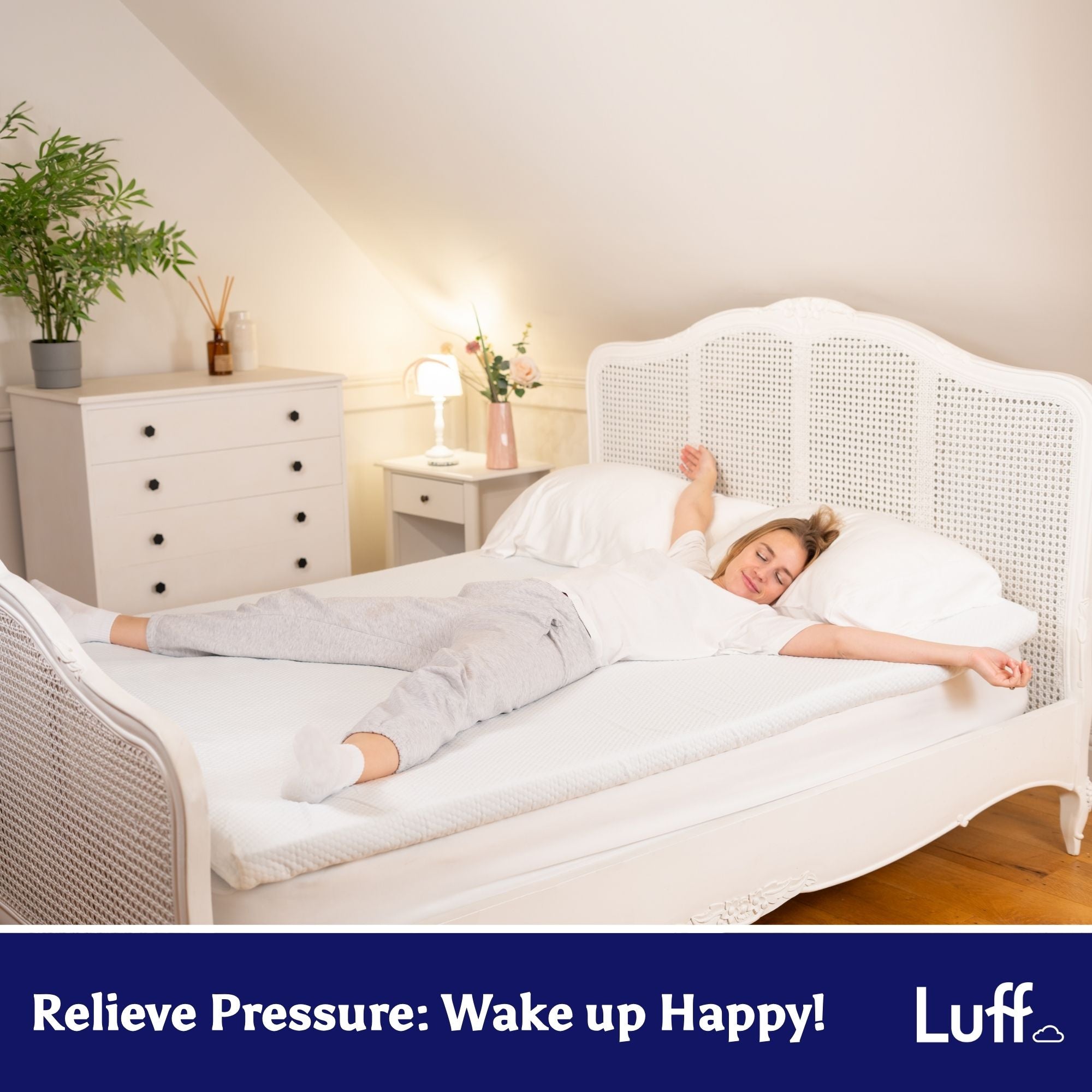 White wicker bed frame with woven lattice design and curved headboard paired with the prestige bamboo mattress topper