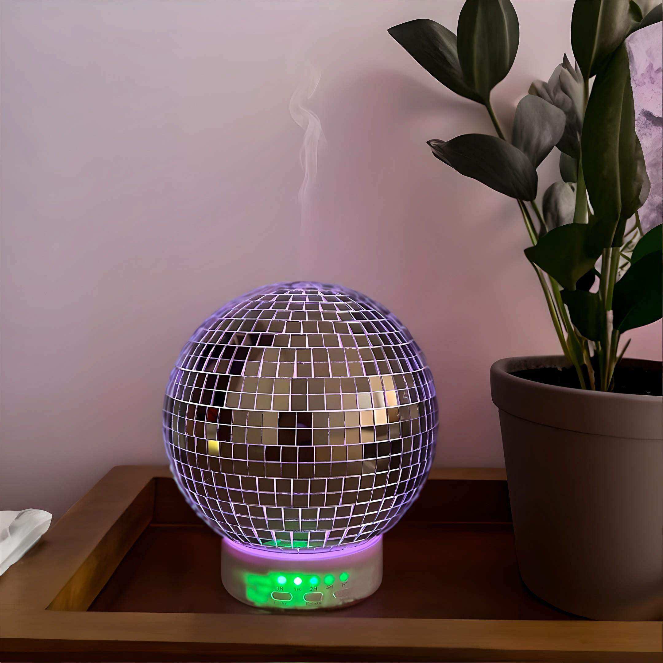 The rotating disco ball diffuser is a mirrored mosaic essential oil diffuser with a glowing purple light base and rotating disco effect