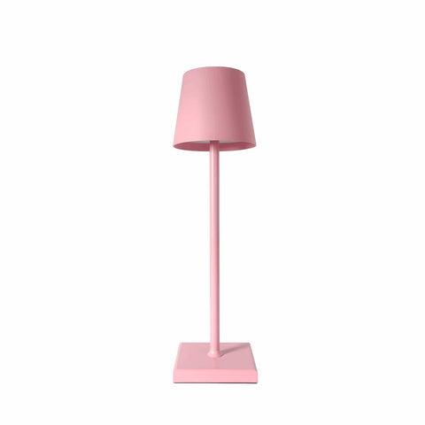 A sleek minimalist pink simplistic wireless led lamp with a cylindrical shade and slender stem for modern lighting