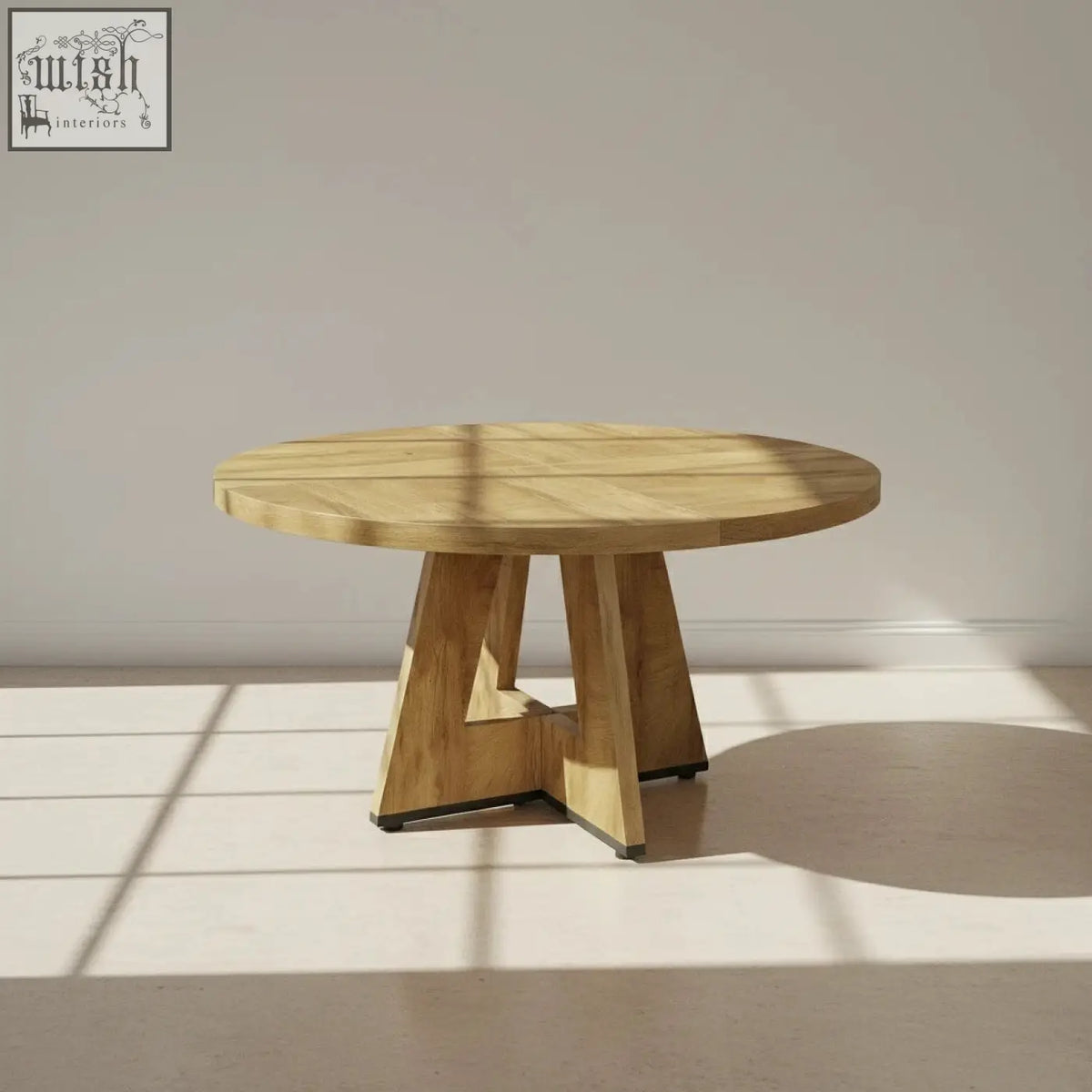 The somerset round oak dining table features a light wood finish and a unique geometrically shaped pedestal base
