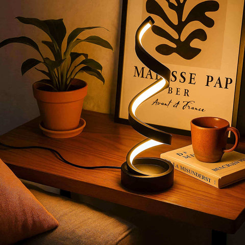 Sleek black spiral table lamp with glowing curved design perfect for modern desk lighting and decor