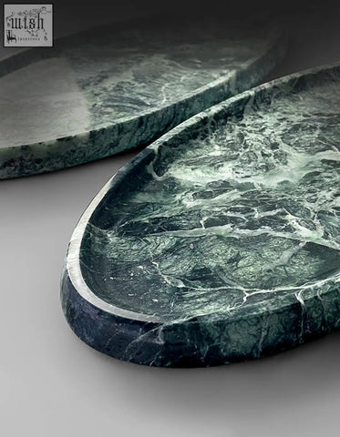 Thelonious plate tray is an elegant oval green marble bathroom tray with white veining and a stylish polished surface