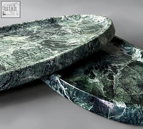 Two oval-shaped thelonious marble trays with deep green and white veining make a stylish bathroom tray option