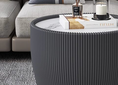 Gray cylindrical coffee table with vertical ribbed texture and white marble top from theo coffee table set black