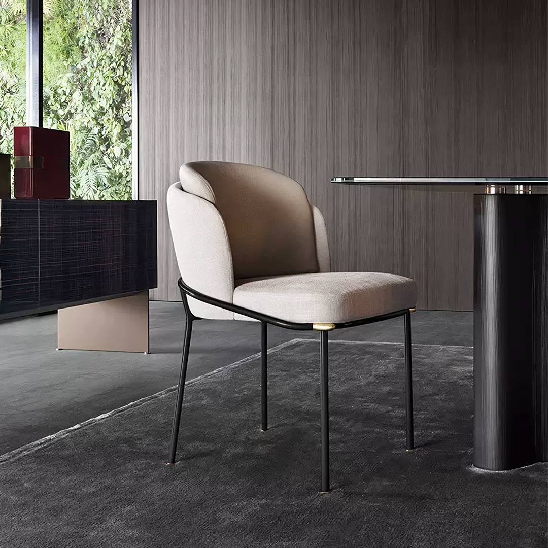 Beige upholstered theobald dining chair with sleek black metal frame and gold-toned accents for stylish dining