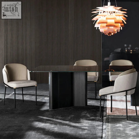 Modern glass top dining table with sleek black pedestal base paired with theobald dining chair grey easy to clean with damp cloth