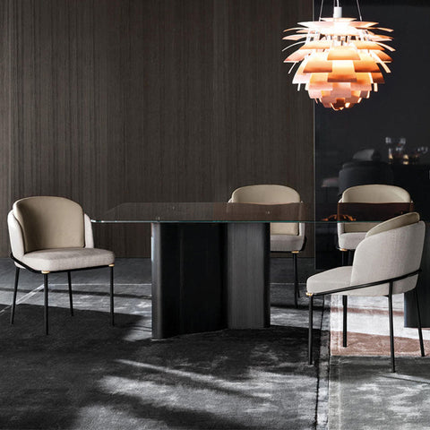 Modern glass-top dining table with sleek black pedestal base paired with theobald dining chair in black