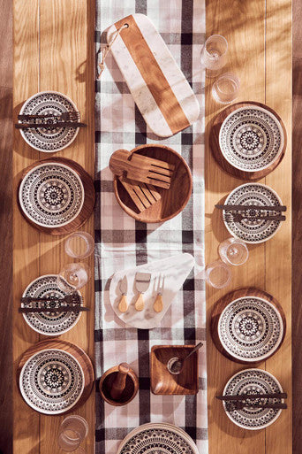 Black and white patterned ceramic plates on thread and loom grey and black check tablecloth perfect for dining setup