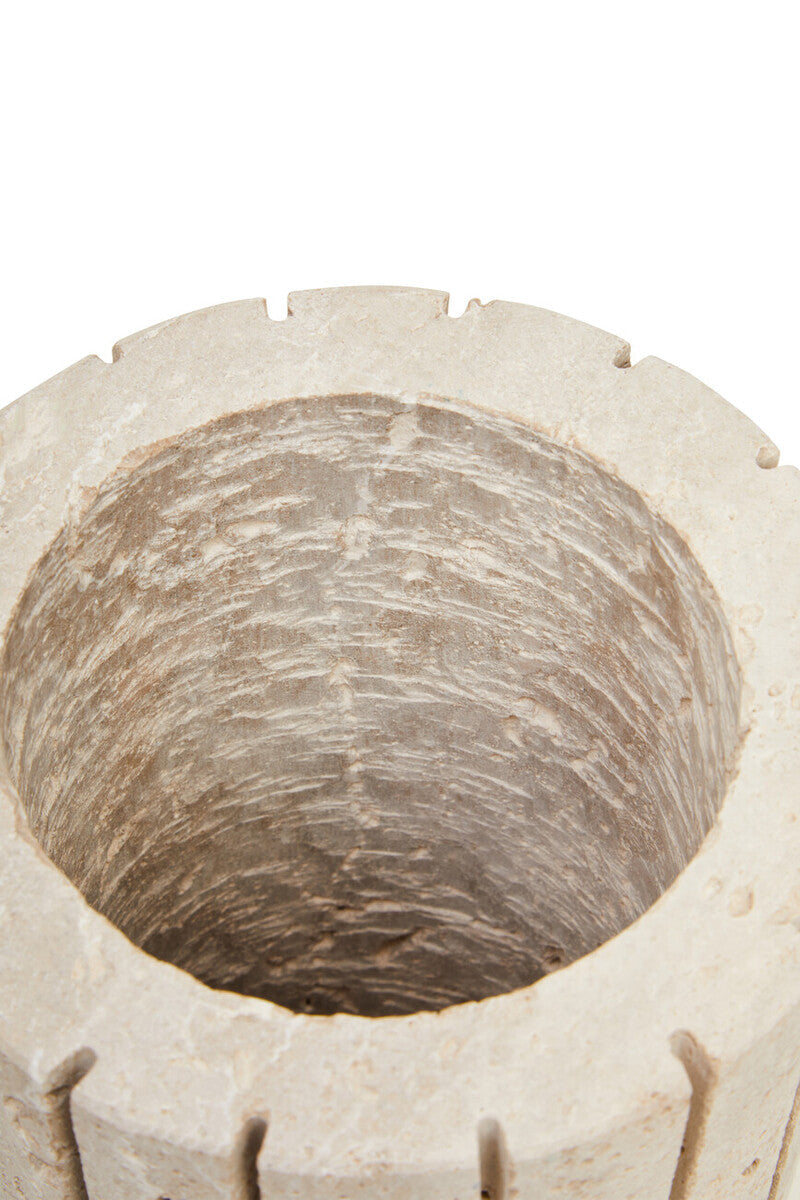 A beige tibor travertine ribbed vase featuring a rustic texture and notched rim perfect as a stone planter