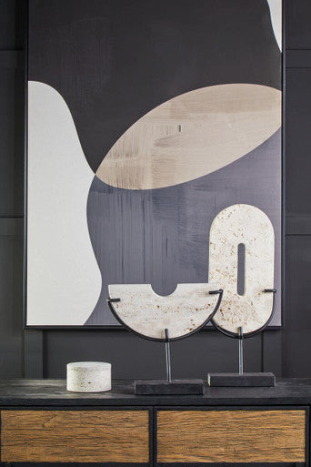 The tibor travertine round trinket box features two curved beige and white marble-like pieces on black metal stands