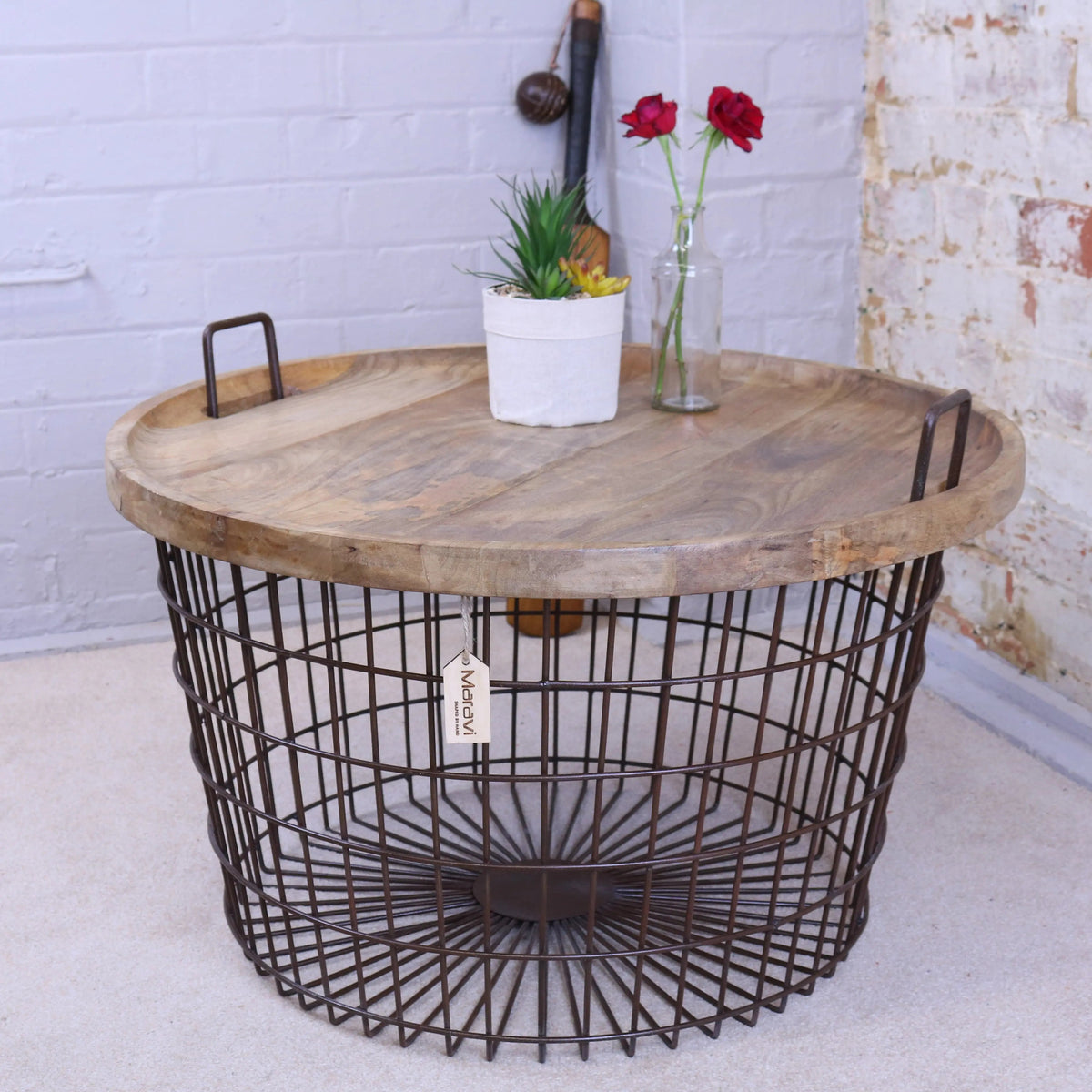 Rustic round industrial basket table with weathered wood top and dark metal wire base with two side handles