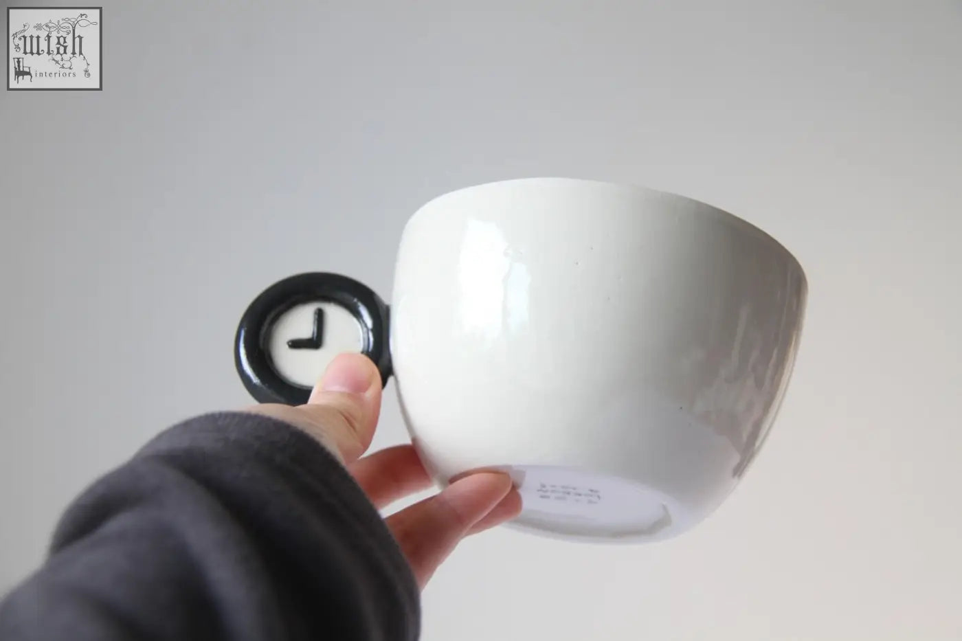 White ceramic time zone cup with black clock face handle showing london and washington time zones