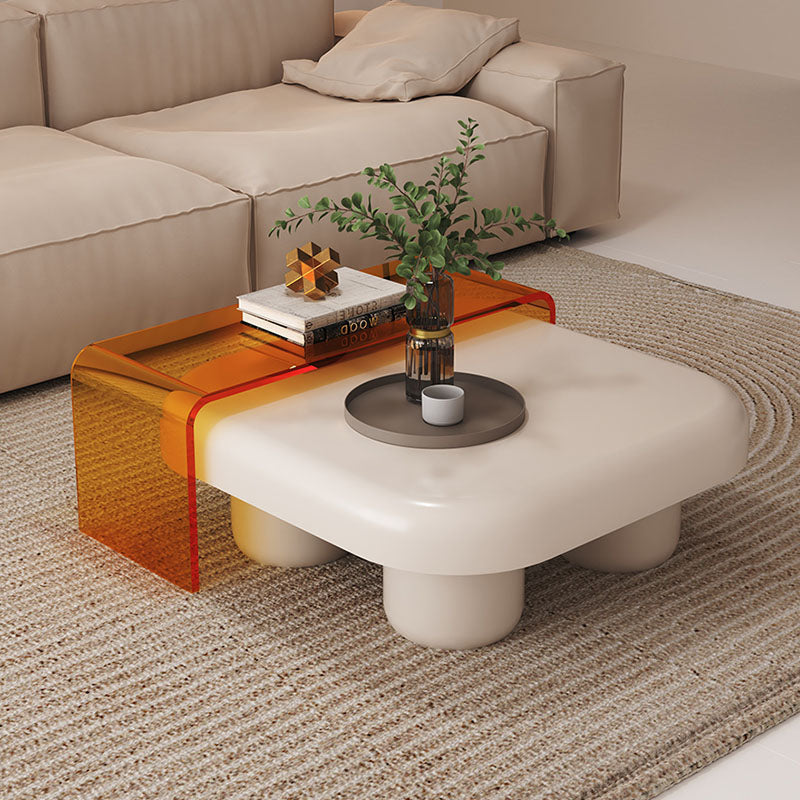 Modern tok mark square nesting coffee table with white rounded top, cylindrical legs, and orange acrylic side panel