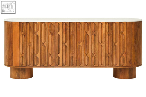 Sleek three door sideboard in mango wood with carved design and white marble top featuring oval motifs