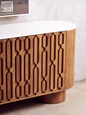 Wooden sideboard with mango wood carved design three doors and white countertop featuring oval cutout patterns