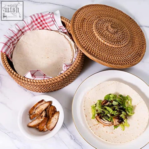 Woven rattan tortilla warmer basket with matching lid and red and white checkered cloth lining for keeping tortillas warm