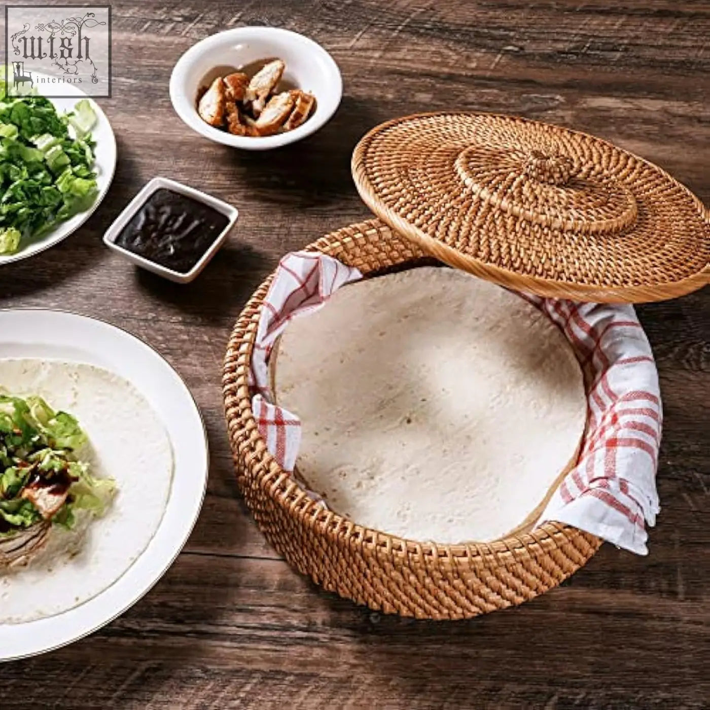 Woven rattan tortilla warmer basket with matching lid and red and white checkered cloth lining for keeping tortillas warm