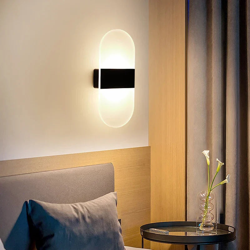 Modern oval-shaped usb rechargeable touch sensor wall light with frosted glass diffuser and black metal frame emitting warm light
