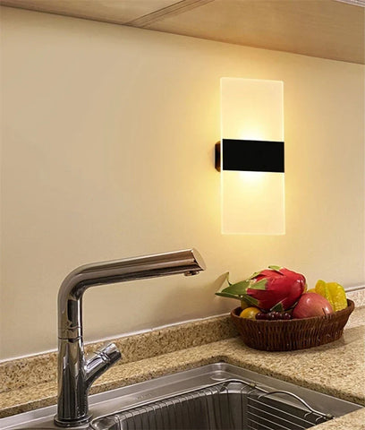 Modern rectangular usb rechargeable touch sensor wall sconce with frosted glass and black accent emitting warm light