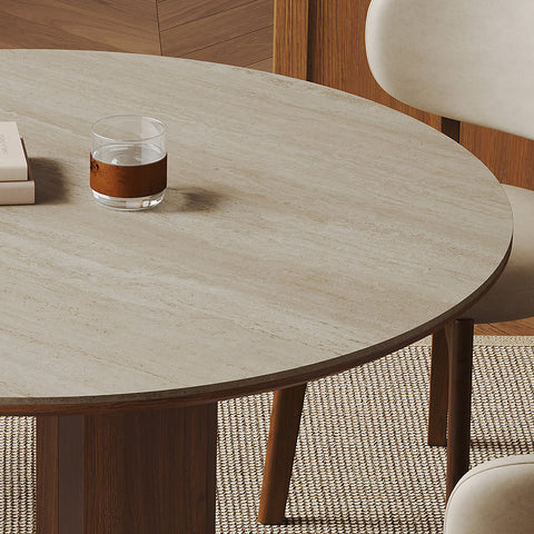 Toure round dining table with a light beige sintered stone top and dark wood legs minimalist round dining table