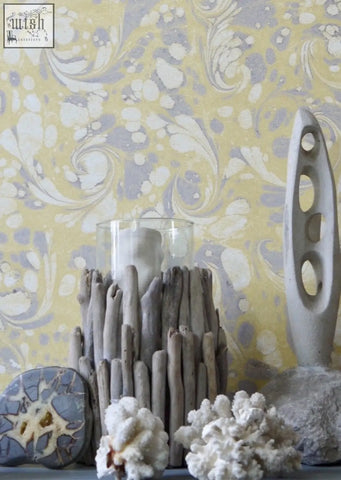 A rustic driftwood candle holder with clear glass cylinder on grayish-brown sticks perfect for tourmaline wallpaper decor check shipping times